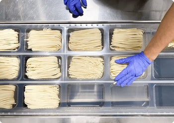 Commercial kitchen and with portions of pasta